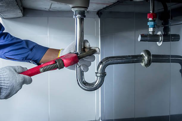 Professional plumber repairing a pipe